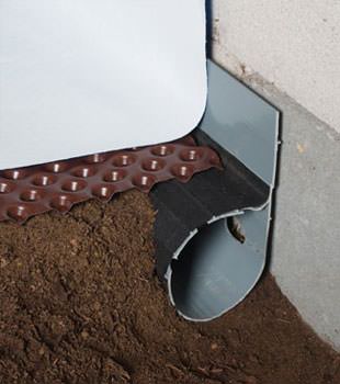 Closeup of a crawl space drainage system installed in Antigonish