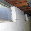 A foundation showing severe inward buckling along the windows in a Bedford home.