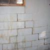 A cracked foundation wall near a window in a New Waterford home