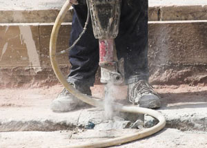 Jackhammering a slab floor in a Sydney home.