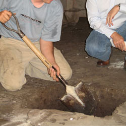 Digging a hole for the engineered fill used in a crawl space support system installation in Dieppe