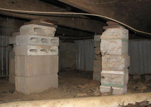 crawl space repairs done with concrete cinder blocks and wood shims in a Amherst home