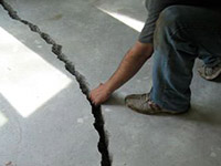 a severely damaged cracked concrete slab floor in Bullhead City