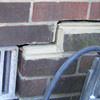 A closeup of a failed tuckpointing job where the brick cracked on a Rusagonis home.