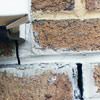 Failed crack repair showing old tuckpointing that cracked on a Fredericton home.