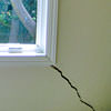 A long, diagonal crack that begins at a window corner of a Kentville home