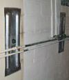 Foundation wall anchor plates installed in a basement in Fredericton