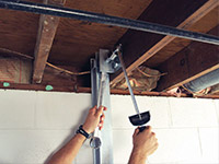 Straightening a foundation wall with the PowerBrace™ i-beam system in a Glace Bay home.