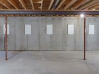 A repaired basement wall with foundation wall anchor covers installed in Sydney.