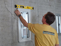 Positioning a wall plate cover on a foundation wall in Dieppe.