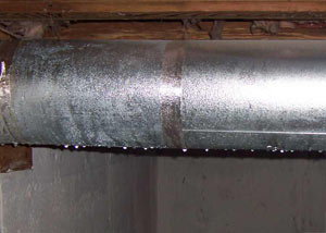 condensation collecting on an HVAC vent in a humid New Glasgow basement