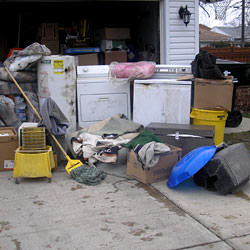 Soaked, wet personal items sitting in a driveway, including a washer and dryer in Dieppe.