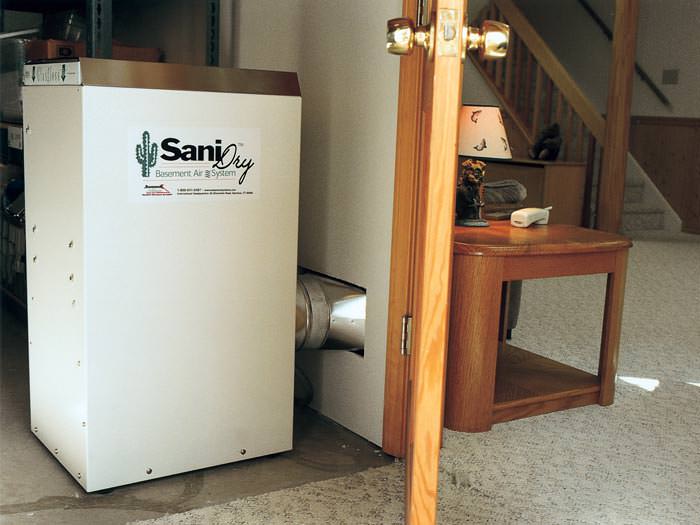 A basement dehumidifier with an ENERGY STAR® rating ducting dry air into a finished area of the basement  in Shediac