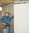 Installing wall panels on top of our basement wall insulation in Dieppe