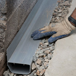 installing a drain tile system in a Quispamsis home